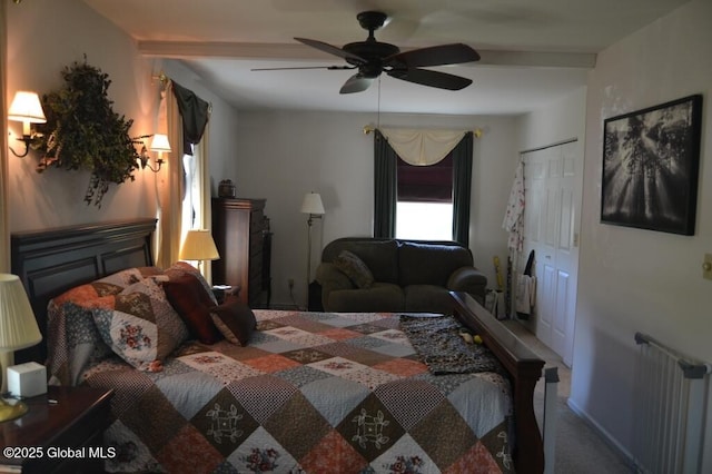 bedroom featuring carpet floors, radiator, ceiling fan, beamed ceiling, and a closet
