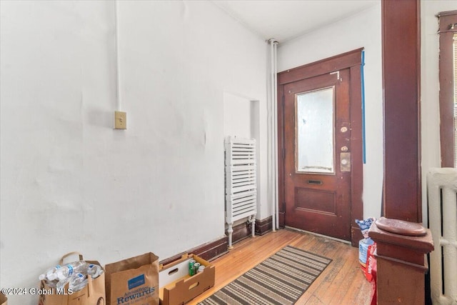 entryway featuring wood-type flooring and radiator