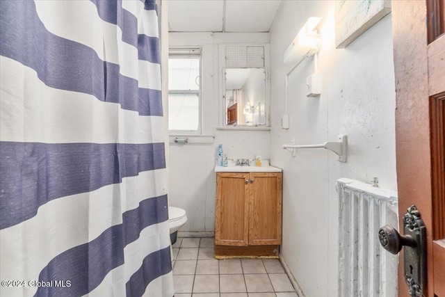 bathroom featuring tile patterned flooring, vanity, toilet, and radiator heating unit