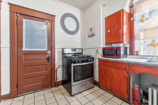 kitchen featuring appliances with stainless steel finishes and light tile patterned floors