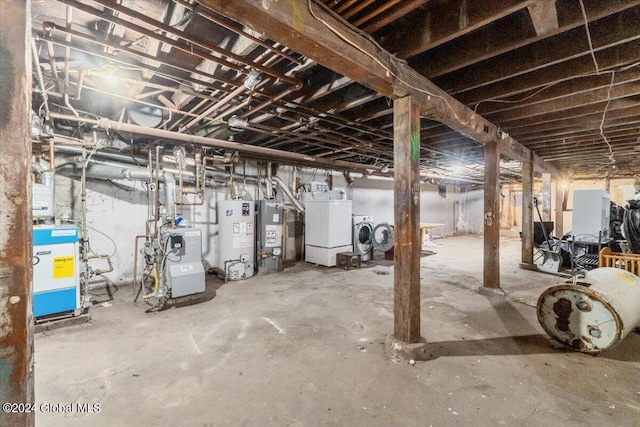 basement with gas water heater and washing machine and clothes dryer