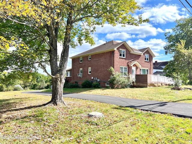 view of side of property with a lawn