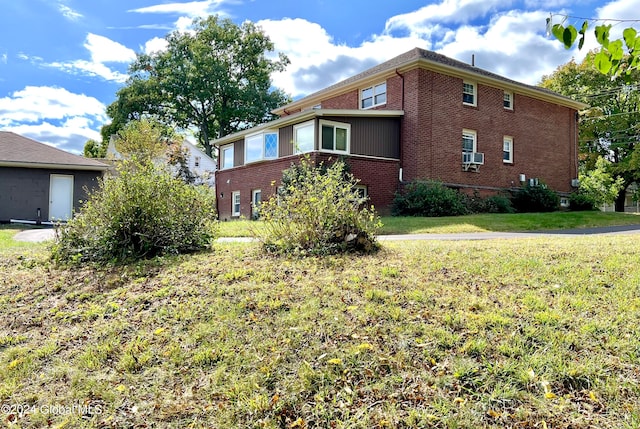 view of side of home with a lawn