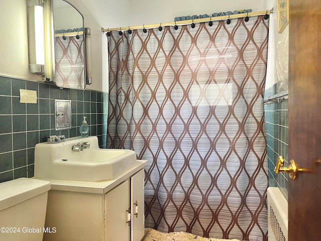 bathroom with vanity, toilet, tile walls, and a shower with shower curtain