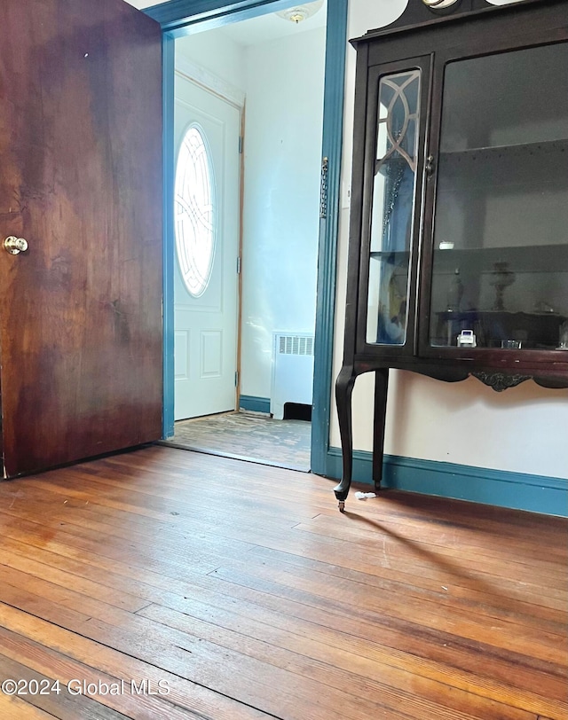 foyer featuring hardwood / wood-style flooring and radiator