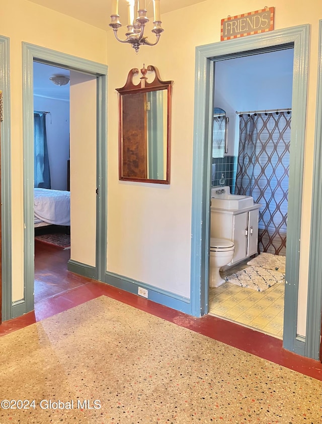 hallway with sink and a notable chandelier