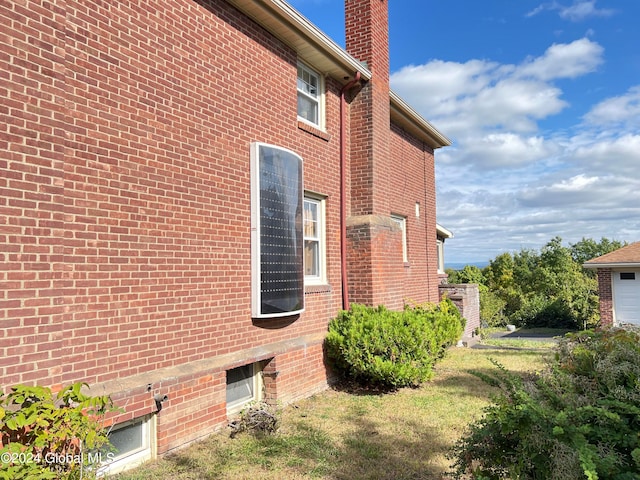 view of side of home featuring a lawn