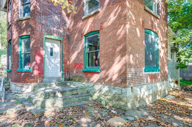 entrance to property featuring brick siding