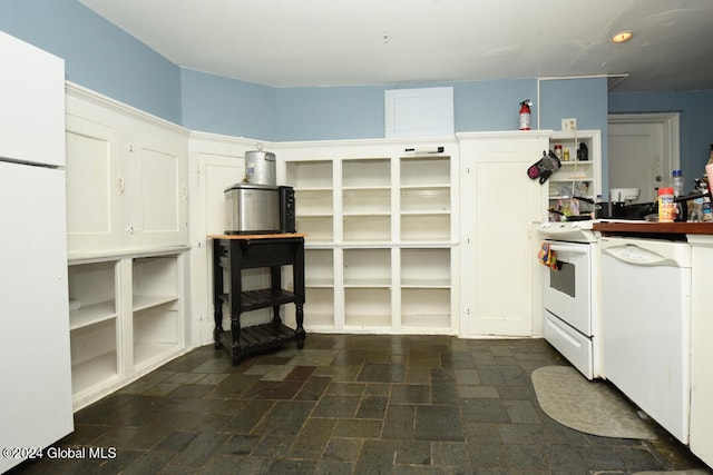 kitchen with white appliances and white cabinetry