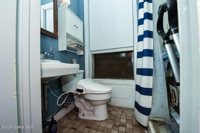 bathroom with a shower with curtain and toilet