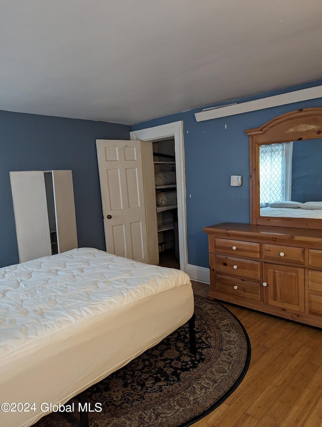 bedroom featuring light wood-type flooring and a closet