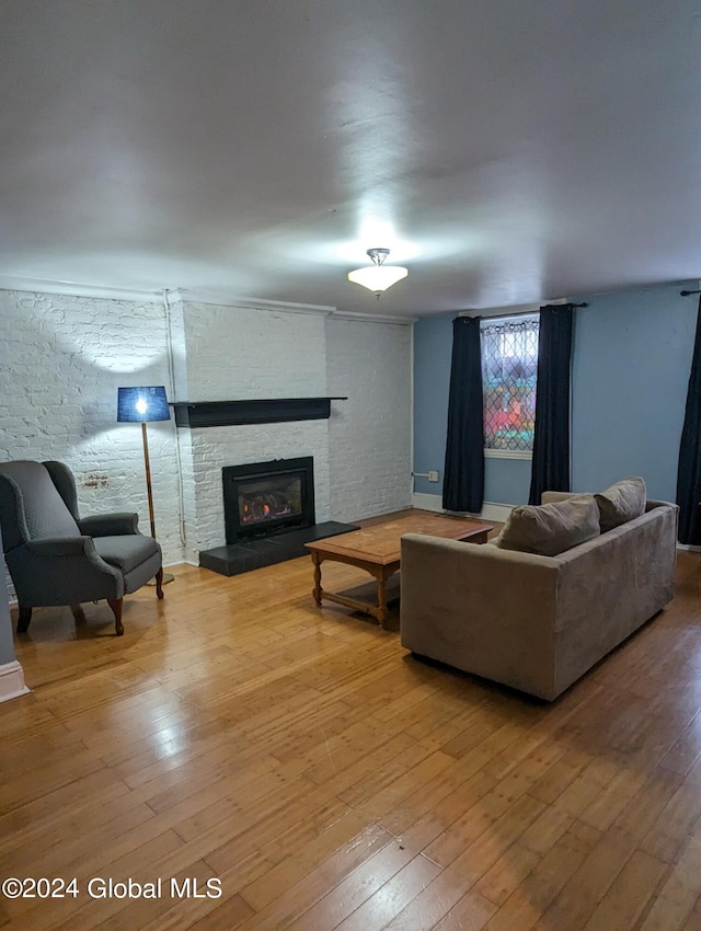 living room featuring hardwood / wood-style flooring and a large fireplace