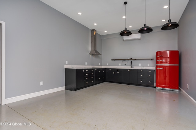 kitchen with pendant lighting, sink, wall chimney range hood, fridge, and concrete flooring