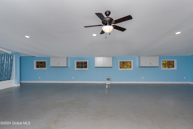 interior space with ceiling fan and concrete flooring