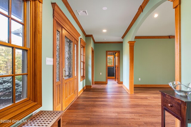 corridor featuring crown molding and hardwood / wood-style floors