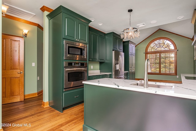 kitchen with light hardwood / wood-style flooring, vaulted ceiling, sink, stainless steel appliances, and kitchen peninsula