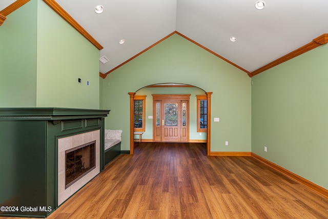 unfurnished living room with lofted ceiling, dark hardwood / wood-style floors, and ornamental molding