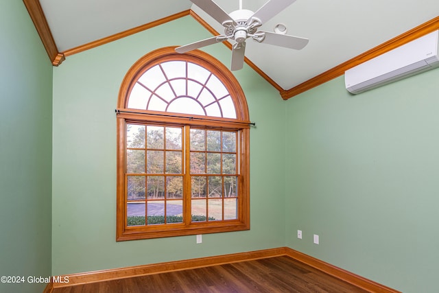 empty room featuring lofted ceiling, a wall mounted air conditioner, hardwood / wood-style flooring, and ceiling fan