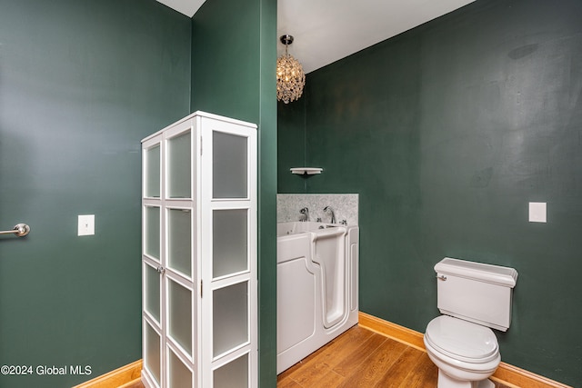 bathroom featuring sink, hardwood / wood-style floors, and toilet