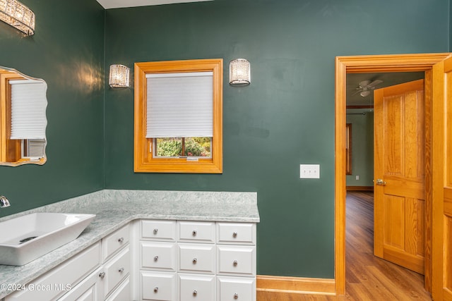 bathroom featuring wood-type flooring, vanity, and ceiling fan