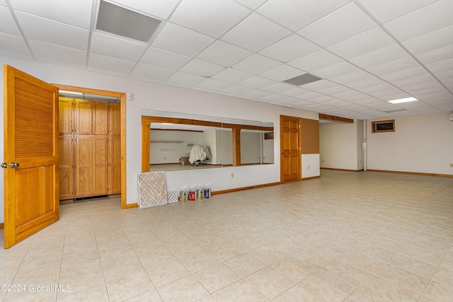 interior space with a paneled ceiling