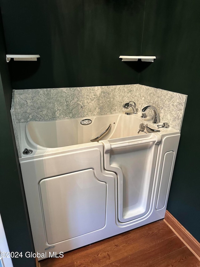 laundry area with hardwood / wood-style floors