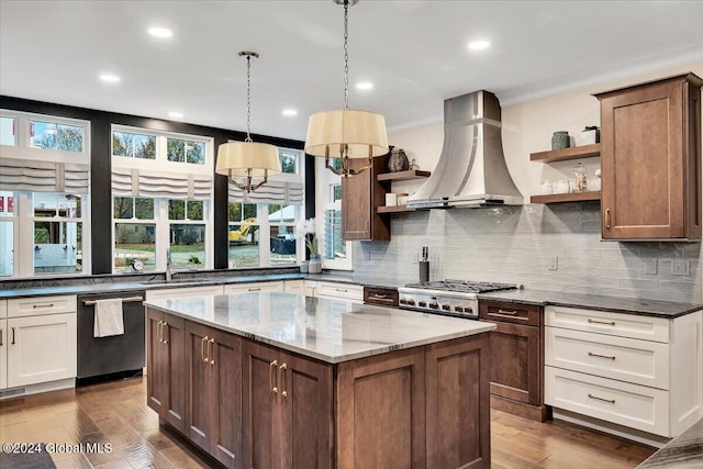 kitchen featuring open shelves, dark stone counters, dishwashing machine, island exhaust hood, and a sink