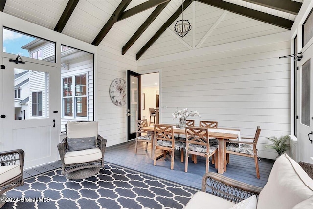 sunroom with lofted ceiling with beams