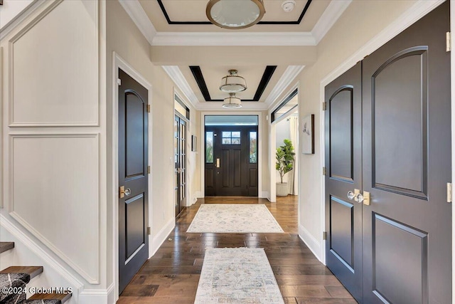 entrance foyer featuring baseboards, crown molding, and dark wood-type flooring