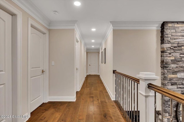 hall featuring hardwood / wood-style floors, baseboards, recessed lighting, ornamental molding, and an upstairs landing