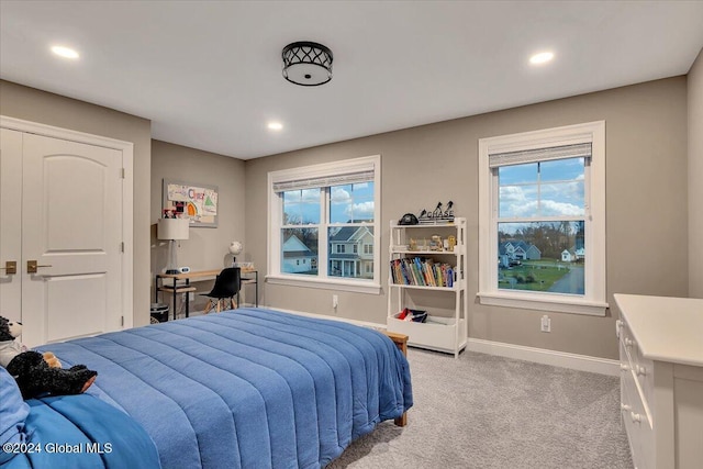 bedroom with recessed lighting, baseboards, and light carpet