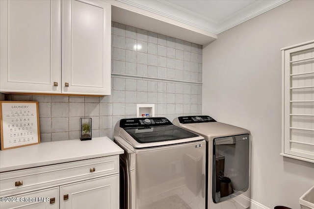 laundry area with tile walls, ornamental molding, cabinet space, and washing machine and clothes dryer