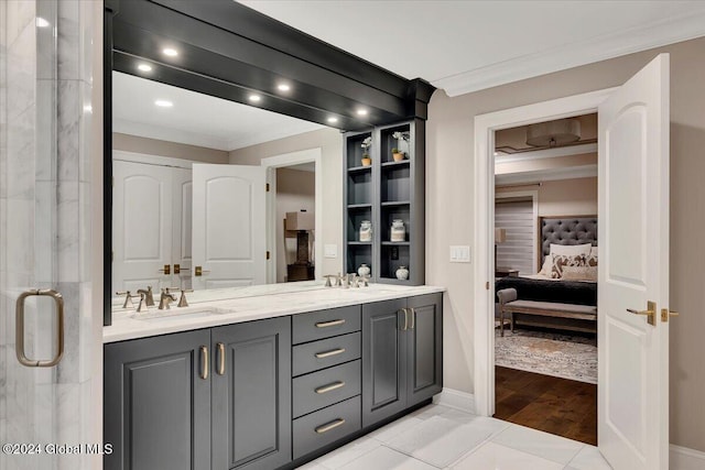 full bath with crown molding, double vanity, ensuite bathroom, tile patterned floors, and a sink