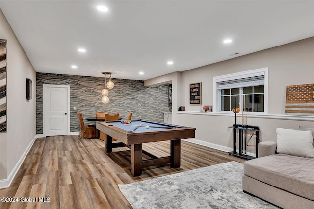 rec room featuring recessed lighting, baseboards, and an accent wall