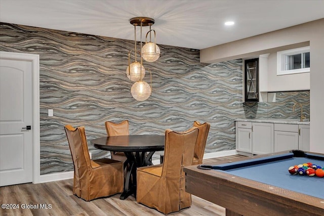 dining space featuring light wood-style flooring and billiards