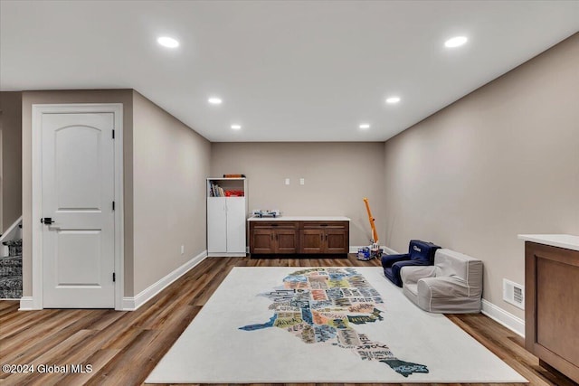 interior space with recessed lighting, wood finished floors, and visible vents