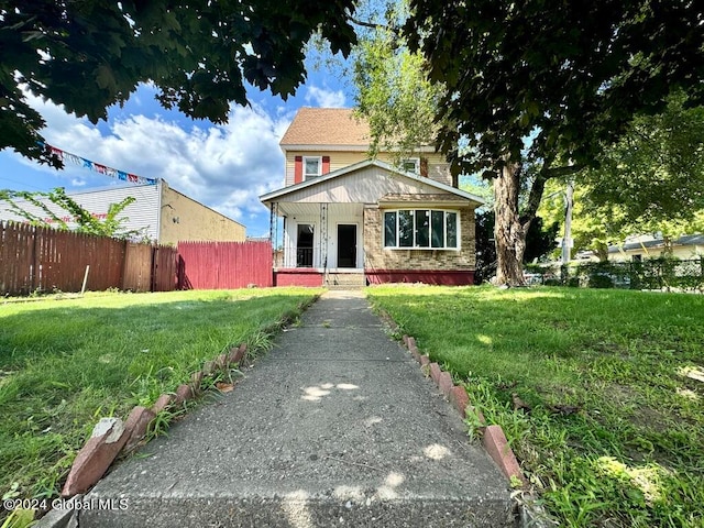 view of front facade with a porch and a front lawn