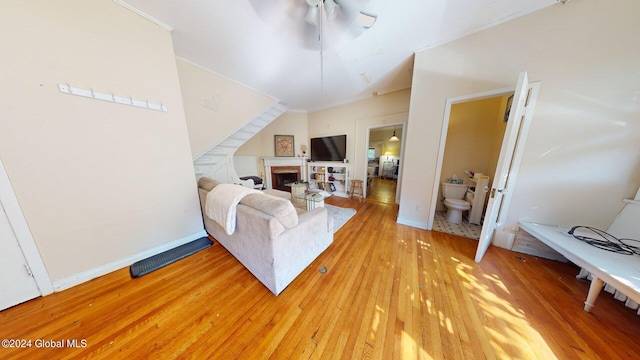 living room featuring ornamental molding, hardwood / wood-style floors, and ceiling fan