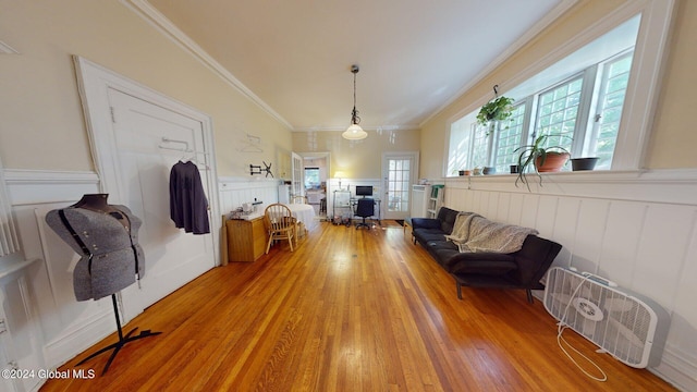 living room with hardwood / wood-style floors and crown molding