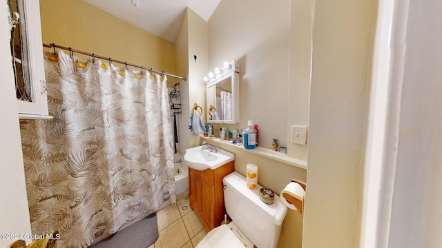 bathroom with a shower with curtain, vanity, tile patterned flooring, and toilet