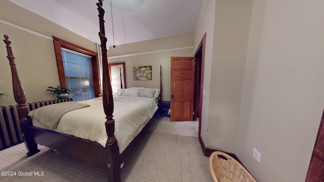 bedroom featuring radiator and light hardwood / wood-style floors