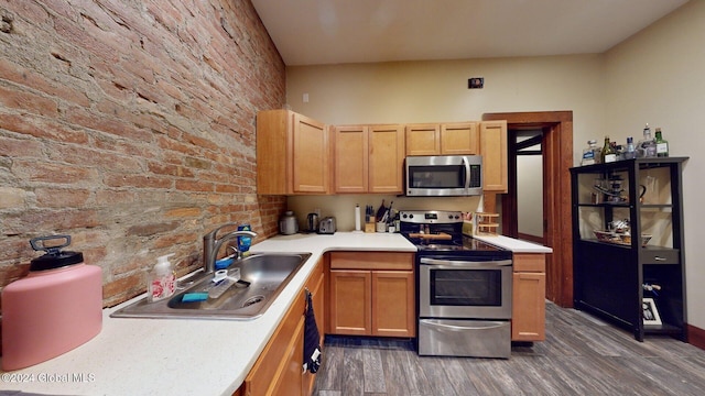 kitchen featuring light brown cabinets, sink, appliances with stainless steel finishes, and dark wood-type flooring