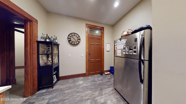 kitchen featuring stainless steel fridge and dark hardwood / wood-style flooring