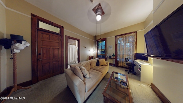 carpeted living room with ceiling fan