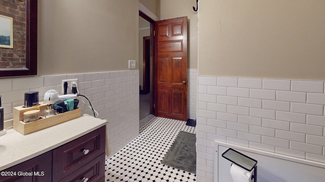 bathroom featuring tile walls and vanity