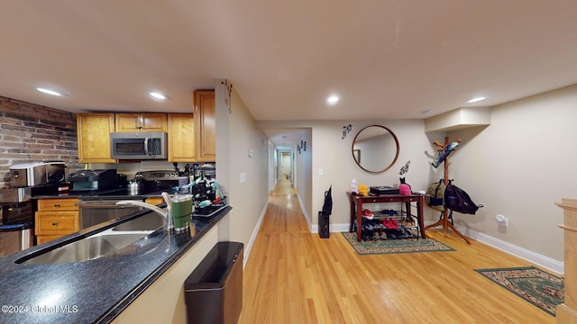 kitchen featuring sink, appliances with stainless steel finishes, and light hardwood / wood-style floors