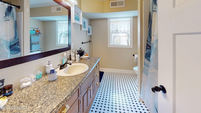 bathroom featuring vanity, toilet, a shower with shower curtain, and tile patterned floors