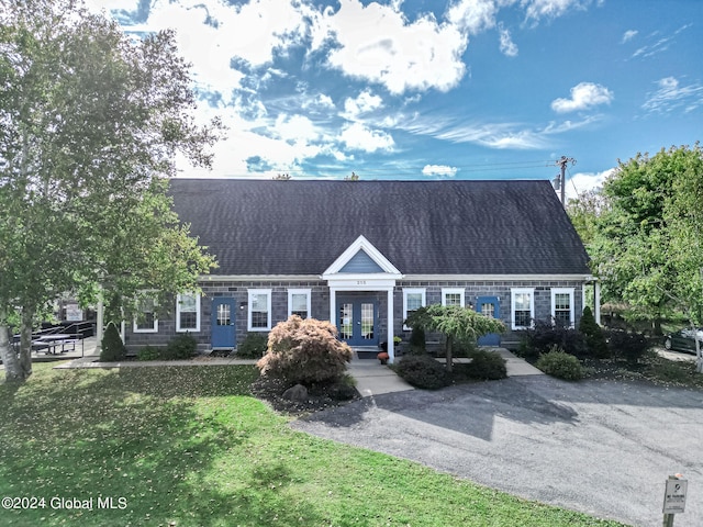 cape cod-style house with a front lawn