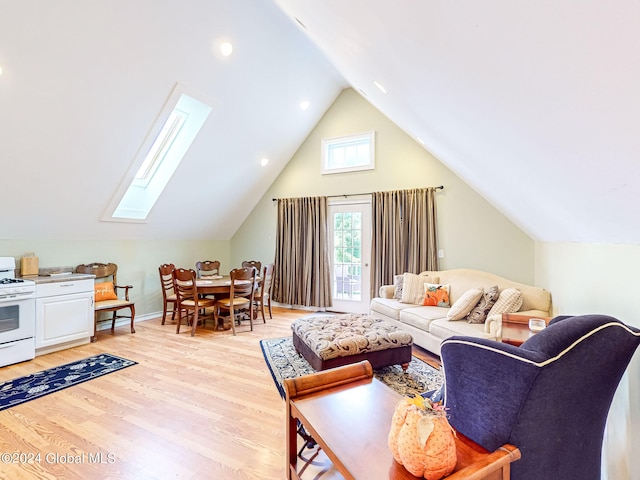 living room with vaulted ceiling with skylight and light hardwood / wood-style flooring