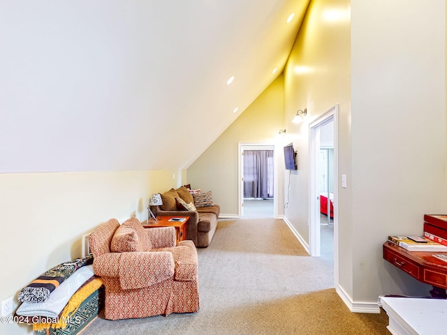 sitting room featuring lofted ceiling and carpet flooring